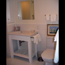 After bathroom remodel with freestanding vanity with built-in sink and new built-in storage